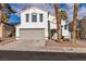 Two-story house with attached garage and landscaping at 7640 Sea Wind Dr, Las Vegas, NV 89128