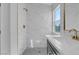 Stylish bathroom with marble shower and gray vanity at 7717 Rainbow Cove Dr, Las Vegas, NV 89131