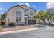 Two story home with a two car garage and landscaping at 7717 Rainbow Cove Dr, Las Vegas, NV 89131