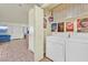 Bright laundry room with washer, dryer, and storage shelves at 901 Rockview Dr # 201, Las Vegas, NV 89128