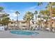 Community pool with surrounding lounge chairs and landscaping at 901 Rockview Dr # 201, Las Vegas, NV 89128