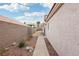 Landscaped backyard with a walkway at 9333 Jumpin Juniper Ave, Las Vegas, NV 89129