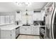 Modern kitchen with white cabinets, stainless steel appliances, and quartz countertops at 9333 Jumpin Juniper Ave, Las Vegas, NV 89129