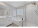 Bright bathroom with soaking tub, shower, and double vanity at 3478 Bradano Ln, Henderson, NV 89044