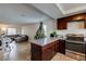 Open kitchen with dark wood cabinets and granite countertops at 4610 Sand Creek Ave, Las Vegas, NV 89103