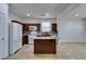 Kitchen with island, dark cabinets, and tile flooring at 7640 Houston Peak St, Las Vegas, NV 89166