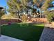 Landscaped backyard with artificial turf and play area at 8308 Raphael Ct, Las Vegas, NV 89129