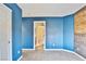 Bedroom with blue walls, closet, and bathroom access at 8897 Bonneville Peak Ct, Las Vegas, NV 89148