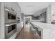 Modern kitchen with stainless steel appliances and gray cabinetry at 1108 Pine Island Ct, Las Vegas, NV 89134