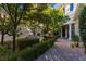 Inviting courtyard entry with lush landscaping and seating at 12056 Royal Dolnoch Ct, Las Vegas, NV 89141