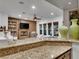 Open kitchen with breakfast bar and view of Gathering room at 12056 Royal Dolnoch Ct, Las Vegas, NV 89141