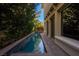 Long, narrow pool with brick coping and spa at 12056 Royal Dolnoch Ct, Las Vegas, NV 89141