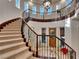 Grand curved staircase with ornate railing at 12056 Royal Dolnoch Ct, Las Vegas, NV 89141