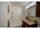 Clean bathroom with shower/tub combo, vanity, and built-in shelves at 203 S Texas Ave, Henderson, NV 89015