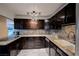 Updated kitchen featuring granite countertops and dark wood cabinetry at 203 S Texas Ave, Henderson, NV 89015