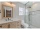 Modern bathroom with marble shower and wood vanity at 2037 Shining Feather Ln, Las Vegas, NV 89134