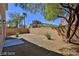 Landscaped backyard with gravel, small trees, and a block wall at 2892 Rothesay Ave, Henderson, NV 89044