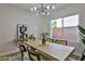 Elegant dining room showcasing a sleek wooden table and modern light fixture at 2892 Rothesay Ave, Henderson, NV 89044