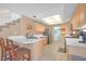 Kitchen with light wood cabinets, stainless steel appliances, and breakfast bar at 3358 Cheltenham St, Las Vegas, NV 89129