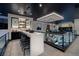 Modern wet bar with white countertop and black cabinetry at 500 Overlook Rim Dr, Henderson, NV 89012