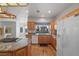 Kitchen with granite countertops, wood cabinets, and a view to backyard at 6460 Spanish Garden Ct, Las Vegas, NV 89110