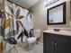 Bathroom with dark vanity, patterned shower curtain, and tiled floor at 6524 Ouida Way, Las Vegas, NV 89108