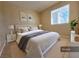 Cozy bedroom with a gray and white checkered bedspread at 6524 Ouida Way, Las Vegas, NV 89108