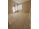 Bright bedroom with tile flooring and large windows at 6524 Ouida Way, Las Vegas, NV 89108