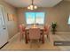 Bright dining room with a light beige rug and six pink chairs at 6524 Ouida Way, Las Vegas, NV 89108