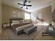 Main bedroom featuring a king-size bed, ceiling fan, and neutral decor at 6524 Ouida Way, Las Vegas, NV 89108