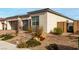 Single-story home with landscaped front yard, two-car garage, and neutral color palette at 8934 Windgate Ranch St, Las Vegas, NV 89166