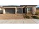 Two-car garage and well-maintained front yard with landscaping at 8934 Windgate Ranch St, Las Vegas, NV 89166