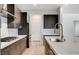 Modern kitchen with dark wood cabinets and a gold faucet at 9002 Shifting Skye St, Las Vegas, NV 89166