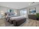 Virtually staged main bedroom with plush bed, light flooring, and large windows at 9002 Shifting Skye St, Las Vegas, NV 89166