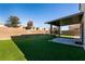 Artificial turf backyard with a pergola and trampoline at 9032 Mackanos Ave, Las Vegas, NV 89148