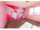 Bedroom with pink and teal accent wall at 9032 Mackanos Ave, Las Vegas, NV 89148