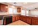 Kitchen with breakfast bar, wood cabinets and view to Gathering room at 9032 Mackanos Ave, Las Vegas, NV 89148