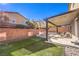 Backyard with covered patio, artificial turf and seating at 10439 Prairie Mountain Ave, Las Vegas, NV 89166