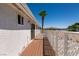 Private deck patio with wood railings, offering views of palm tree and mountains at 136 Greenbriar Townhouse Way, Las Vegas, NV 89121