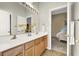 Double vanity bathroom with a view into a bedroom at 2110 Mooreview St, Henderson, NV 89012