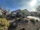 Landscaped front yard with gravel, drought-tolerant plants, and a palm tree at 2420 Ailsa Craig St, Henderson, NV 89044