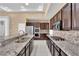 Kitchen with granite countertops, stainless steel appliances, and dark cabinets at 2714 Langlade Ave, Henderson, NV 89052