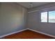 Bright bedroom with wood flooring, ceiling fan, and window at 3200 E Owens Ave, North Las Vegas, NV 89030