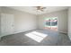 Bedroom with gray carpet, sliding glass doors to the pool at 3920 Syracuse Dr, Las Vegas, NV 89121