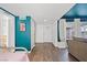 Hallway with teal walls and hardwood floors leading to other rooms at 3951 Avonwood Ave, Las Vegas, NV 89121