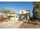 Two story house with tan exterior, a two car garage, and a landscaped front yard at 434 Fortissimo St, Henderson, NV 89011