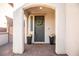 Gray front door with a wreath, flanked by potted plants at 434 Fortissimo St, Henderson, NV 89011