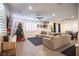 Spacious living room with L-shaped sectional sofa, Christmas tree, and large windows at 434 Fortissimo St, Henderson, NV 89011