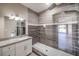 Modern bathroom with walk-in shower and granite countertop at 4813 W Richmar Ave, Las Vegas, NV 89139