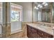 Bathroom with a vanity, sink, and large mirror reflecting a view at 4813 W Richmar Ave, Las Vegas, NV 89139